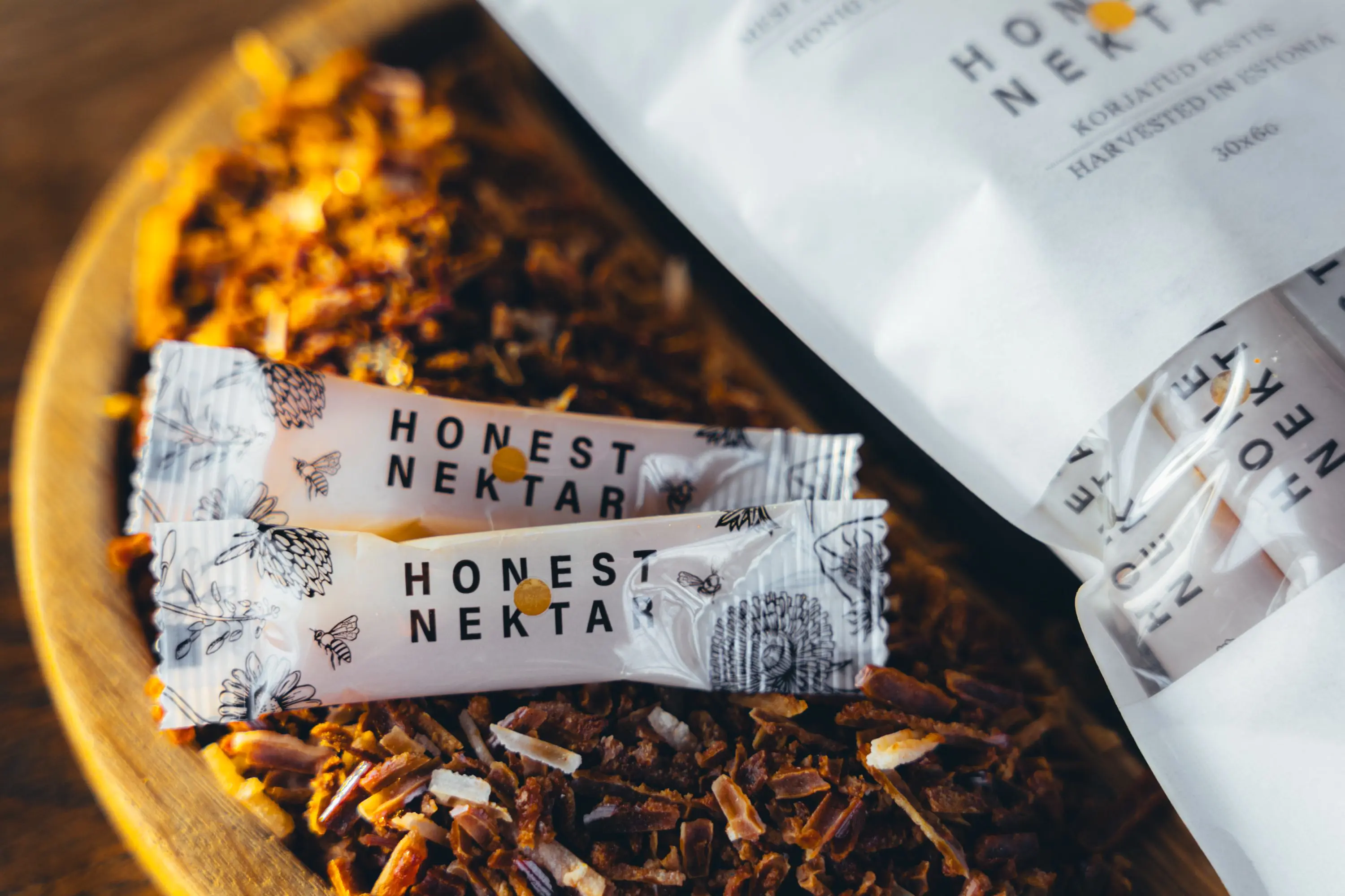 HONEST NEKTAR honey with propolis sticks out of bags untop of propolis.jpg